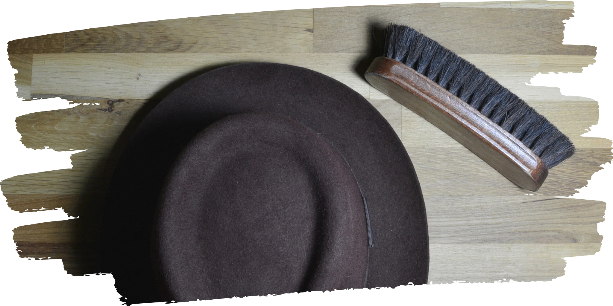 Brown felt hat alongside a wooden hat brush, showcasing Agnoulita Hats' care instructions