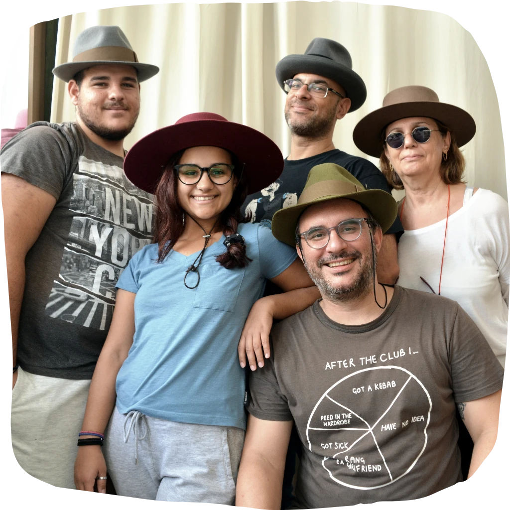 Happy family of five wearing various styles of Agnoulita Hats, showcasing their love for diverse hat designs