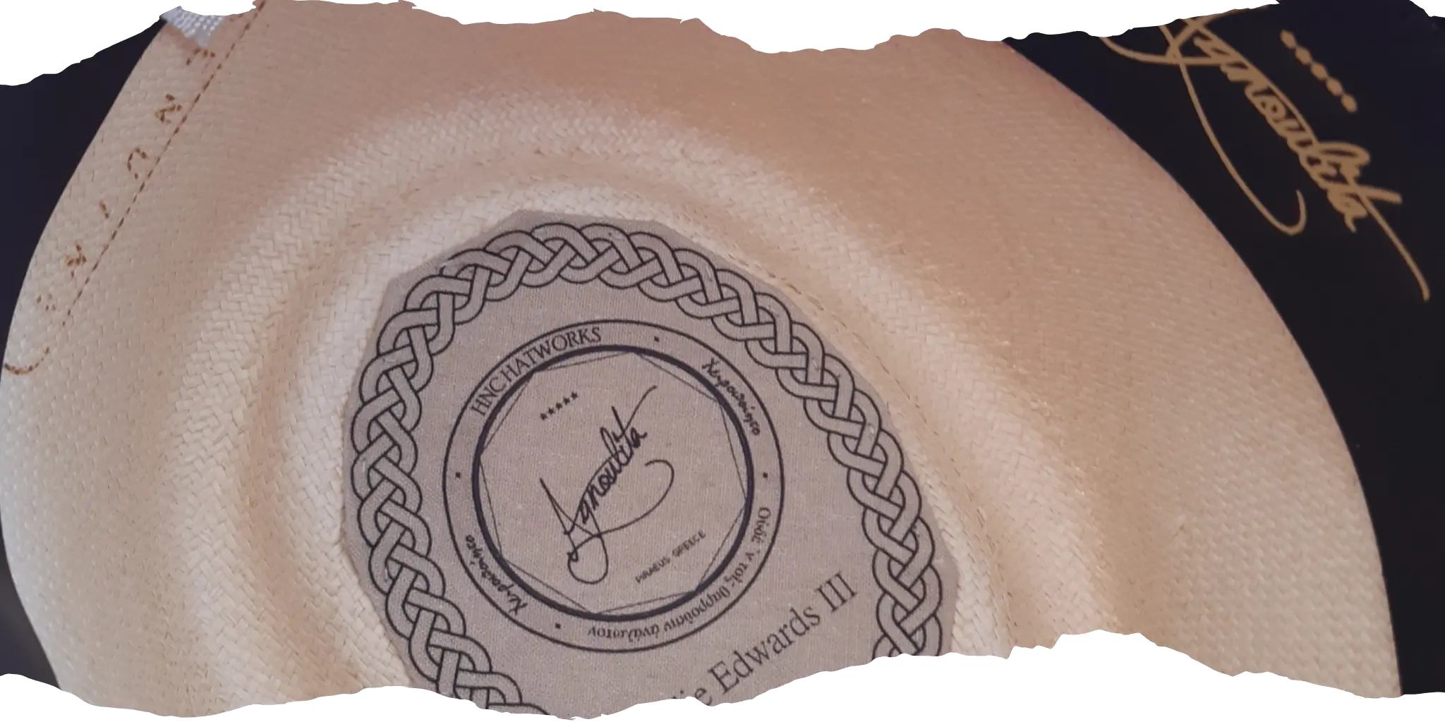 Interior view of a Panama hat showcasing the Agnoulita Hats label and detailed craftsmanship, with woven natural fiber texture and elegant signature.