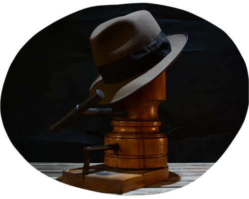 Artfully displayed custom fedora on a wooden hat block, spotlighting the intricate craftsmanship and timeless style of traditional hat making.